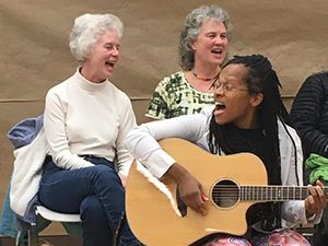 Lea leading a song at a Washington Revels Community Sing